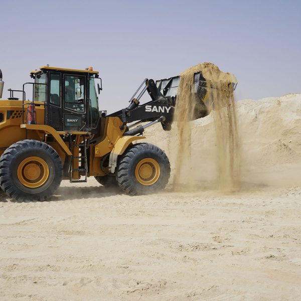 Image of a 5 Tonne Wheeled SANY In Action Handling Sand